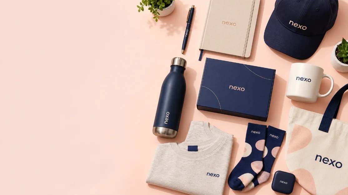 Branded merchandise in navy and cream: notebook, cap, bottle, mug, sweatshirt, socks and tote